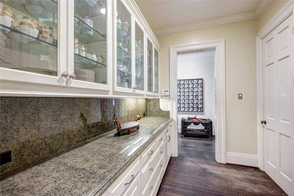 The Butler’s Pantry is situated between the Dining Room and the Grand Hall, and it offers an abundance of glass-front cabinets and ample drawers. The Butler’s Pantry includes an elevator to all three floors and a silver closet.