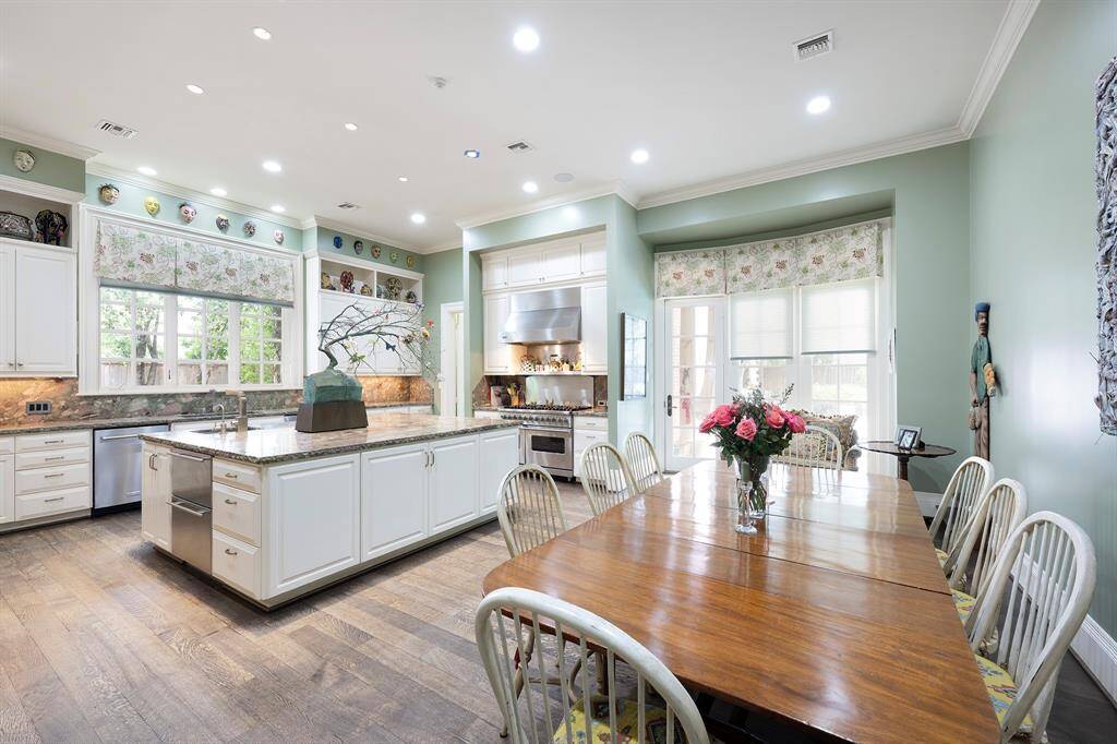 Experience the inviting ambiance of the kitchen and breakfast room, complete with convenient access to a charming covered patio—perfect for enjoying your morning coffee in a serene setting!