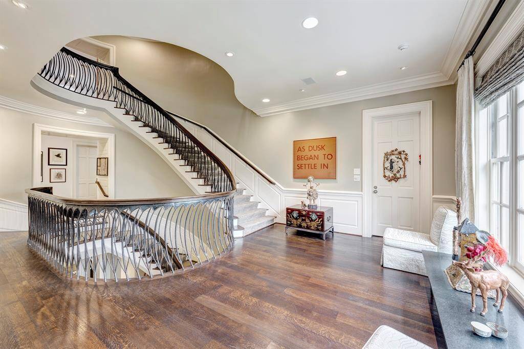 The second-floor landing offers a delightful view of the staircase leading to the third floor. The hardwood flooring lends a rich feel, while the artistic iron staircase offers a lovely accent to the landing. The landing also allows access to the primary bedroom and other bedrooms on the second floor.