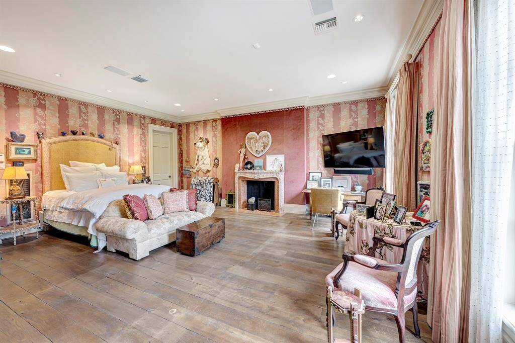 Primary suite featuring reclaimed hardwood flooring and an antique marble mantle with surround. It is easily accessible from the second floor landing or the front back hall, with elevator access available if needed.