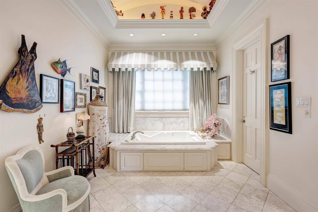 Unwind in the spacious jetted tub adorned with marble decking. Enjoy the privacy of a water closet and easy access to the dressing room, which includes two walk-in closets.