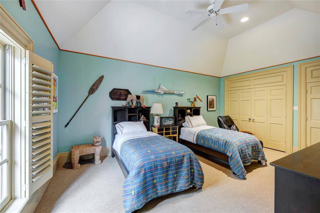 Bedroom five, just off of the gameroom, is the perfect guest suite. It has two walk-in closets, a hall bathroom, and is very private in the back wing of the house.