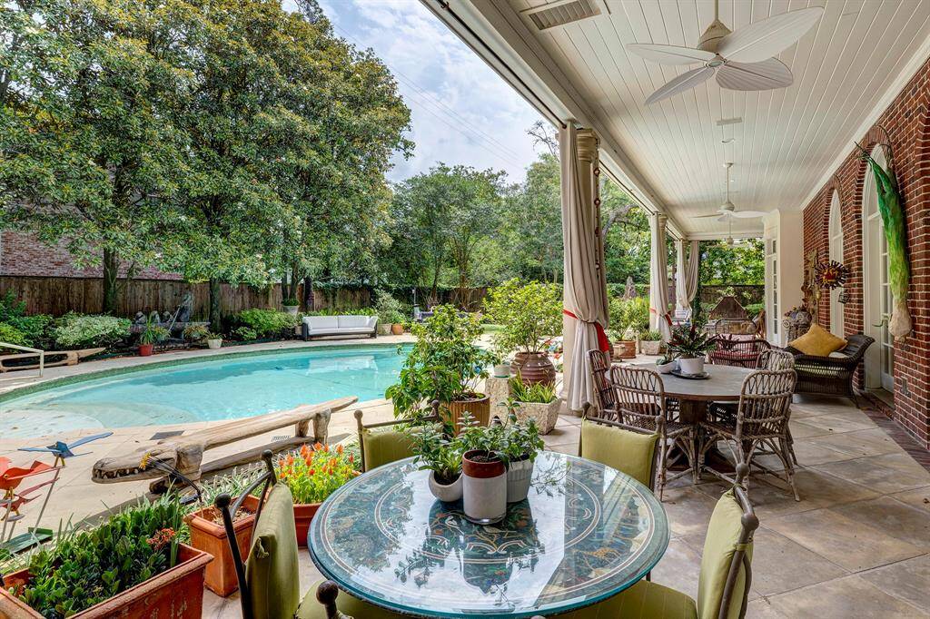 In this private oasis, you can relax and enjoy the shade of the magnolia trees, which screen the property for privacy. You can splash and relax in the heated oval pool, complete with water features and a sitting edge that encircles the pool.