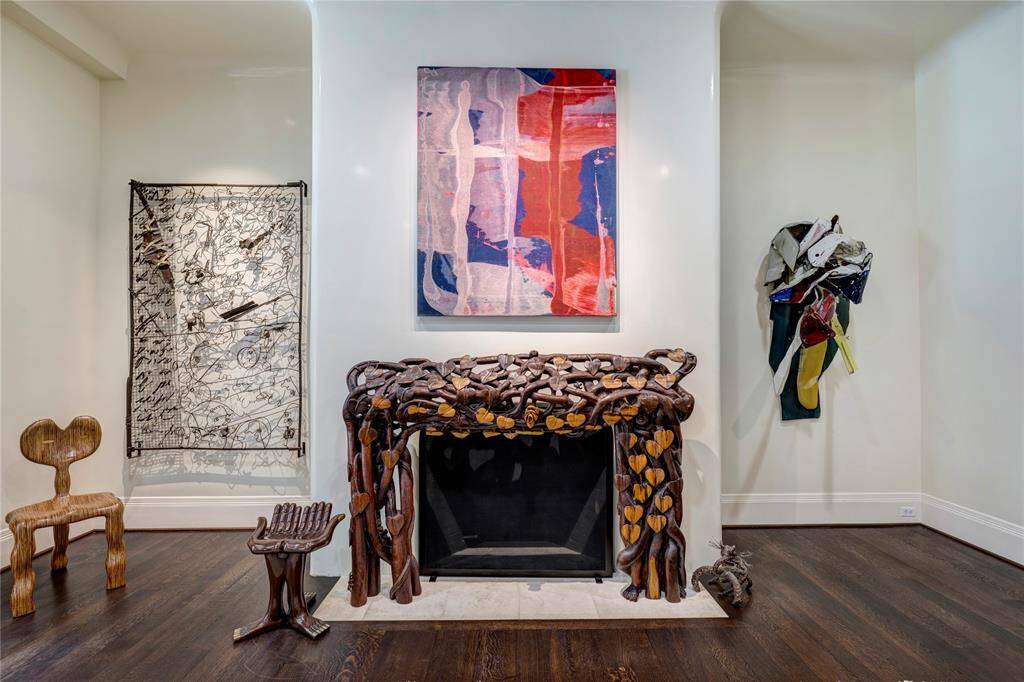 Experience exquisite architectural details with a glossy lacquer finish and a striking stone hearth that creates an inviting atmosphere (please note that the custom carved wood surround is not included).