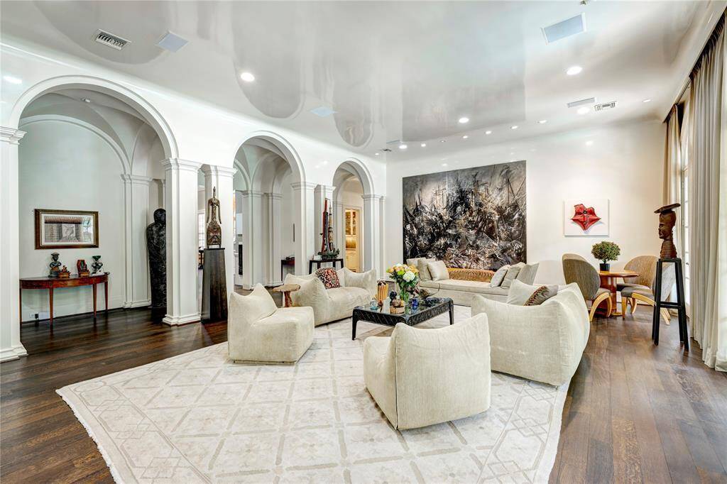 Impressive grand entrance hall, where striking arch openings and beautifully crafted custom columns elevate your experience, all enhanced by the elegance of a sophisticated groin ceiling treatment.