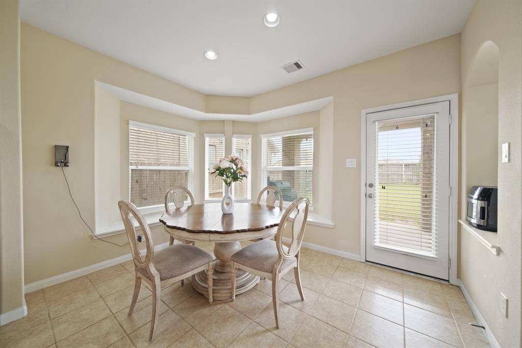 Breakfast room opens to the extended covered patio.
