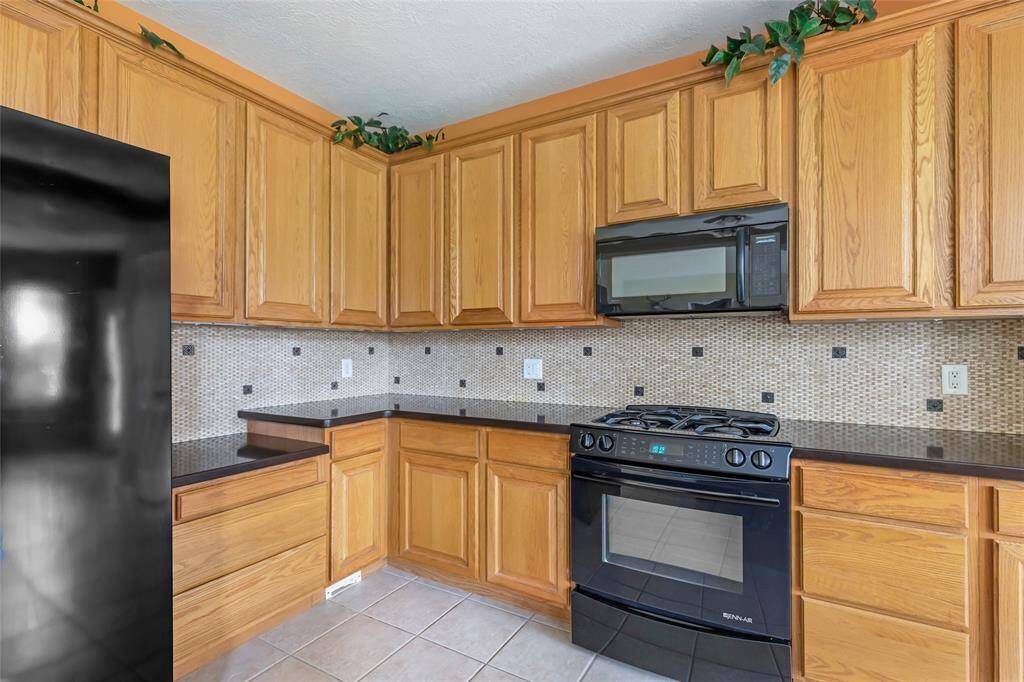 Jenn-Air cooktop/oven & Microwave...  A wall of cabinets for storage...