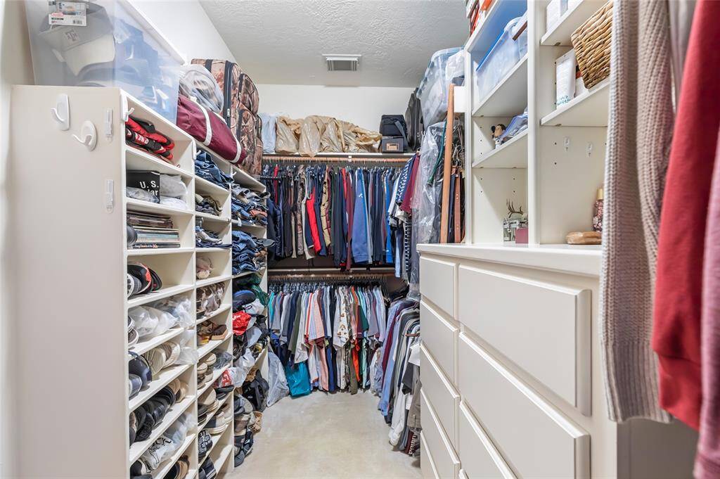Primary - Walk in closet with great shelves for storage & built in drawers...