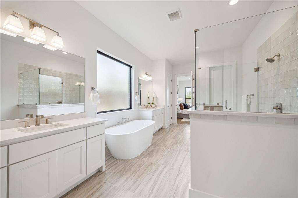 Primary Bath has separate vanities, deep soaking bathtub, walk-in shower, and 2 closets!