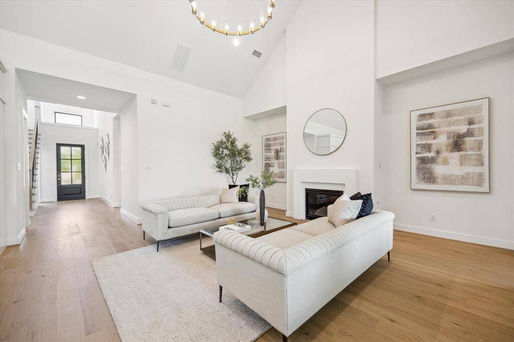 Welcome home! The Living Area has high, sloped ceiling with on-trend light fixtures, and gas log fireplace.