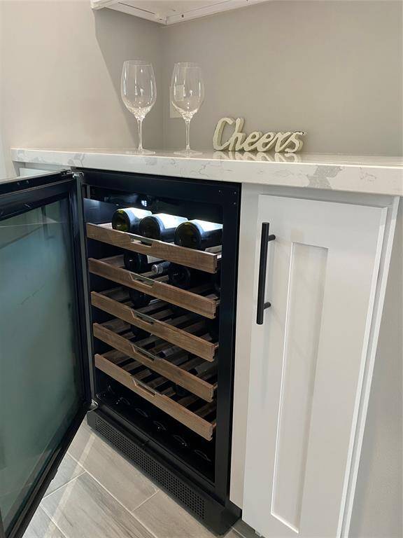 top of the line Electrolux 42-bottle wine refrigerator offers nice wood rolling shelves