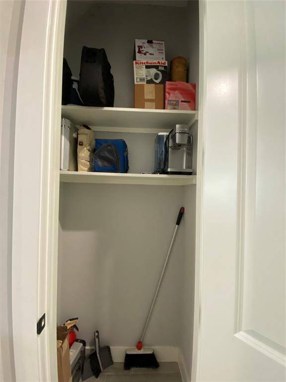 This broom closet/storage is located in the hall across from the pantry.