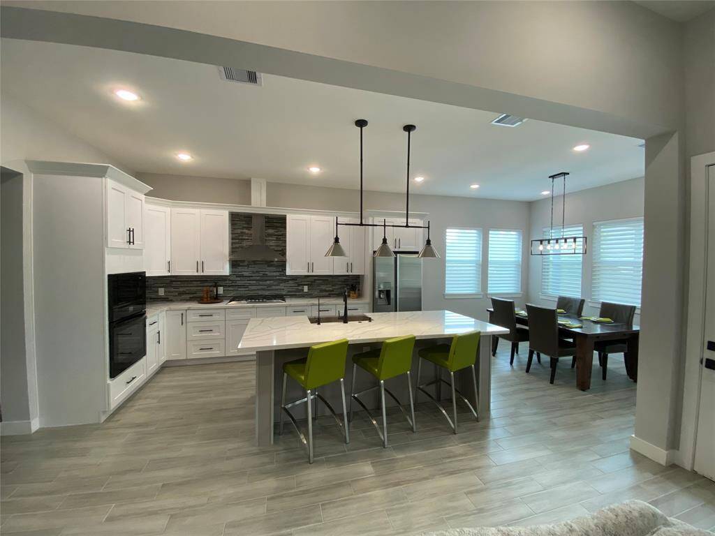Quartz island open to the dining and living area.  All Bali sheer shades are programmable.