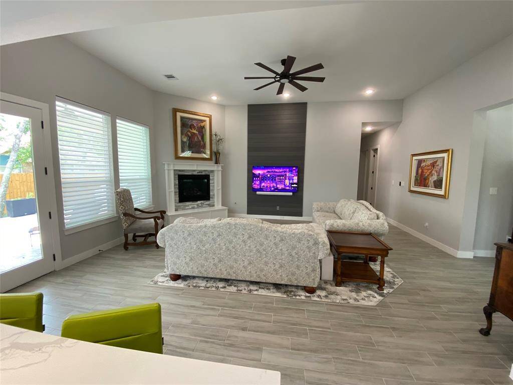 Living area includes remote control gas fireplace and custom rug