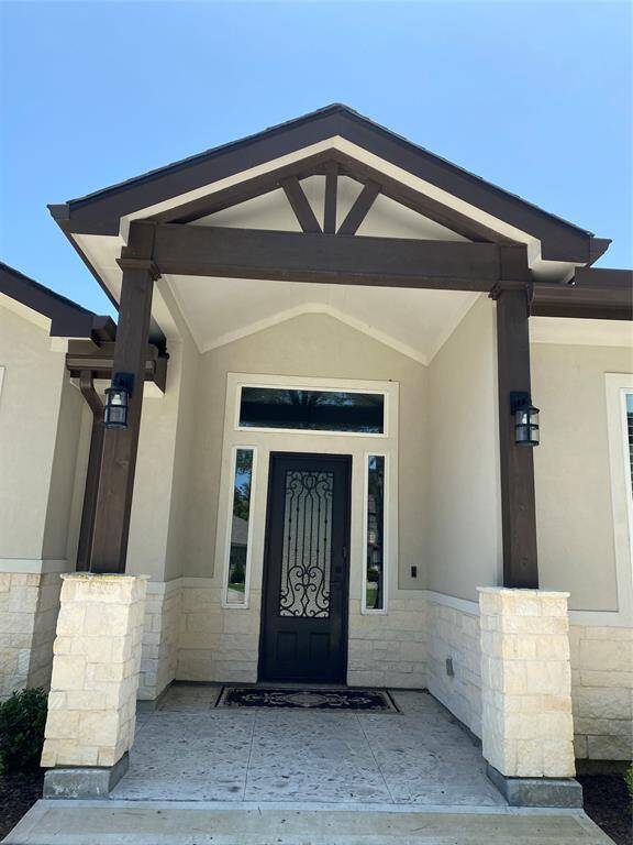 Impressive foyer with stamped concrete and beautiful iron door. All outdoor lighting is programmable and dimmable on Smart Things automation hub.