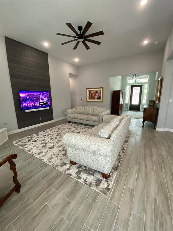 Custom tv feature wall includes hidden mount, wire hider and outlet. Great flow through this floor plan.