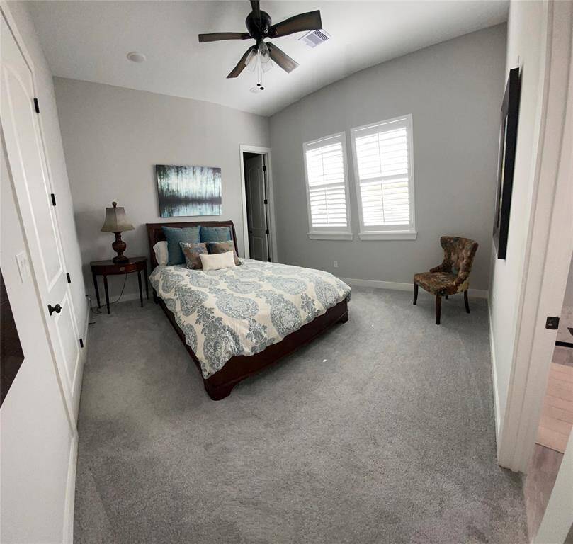 Guest bedroom #2 has room to fit a queen bed nicely as well a sitting area, a walk-in closet, plantation shutters and en-suite bath.