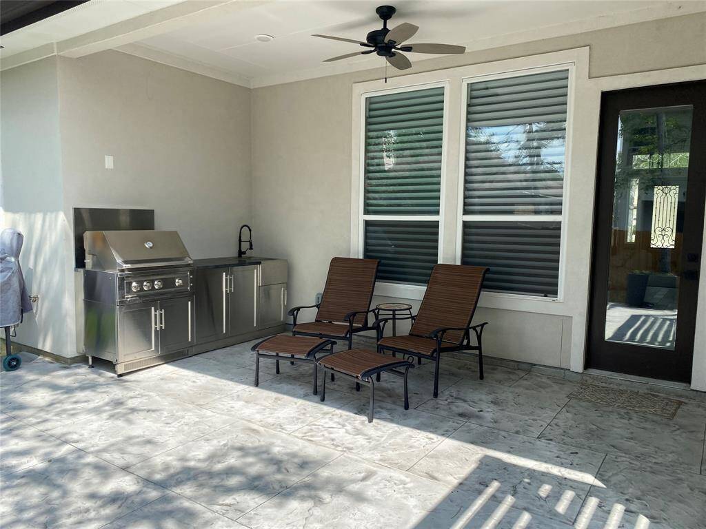 Stainless steel outdoor kitchen features ample storage, granite top and hot/cold water sink
