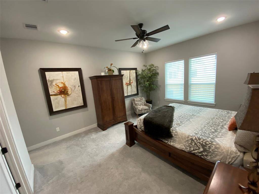 Spacious primary bedroom with separate HIS and HER closets