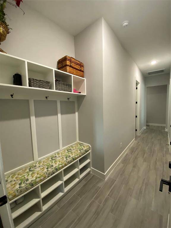 Entering from the garage, drop your belongings at this efficient mud room with cute banquette.