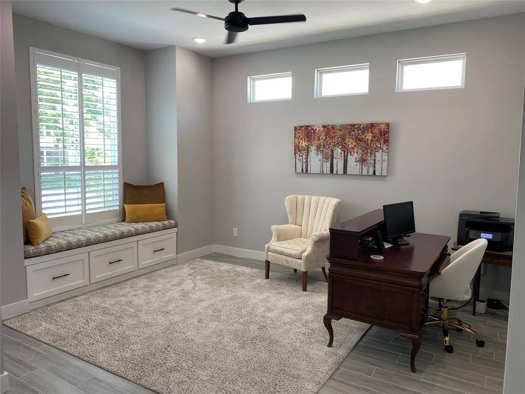 This flexible front room connects to the foyer and includes matching custom rug and plantation shutters.