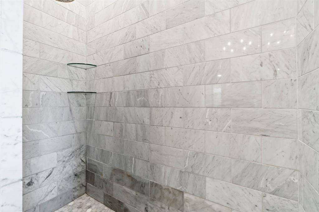 walk in tiled shower in the primary bathroom.
