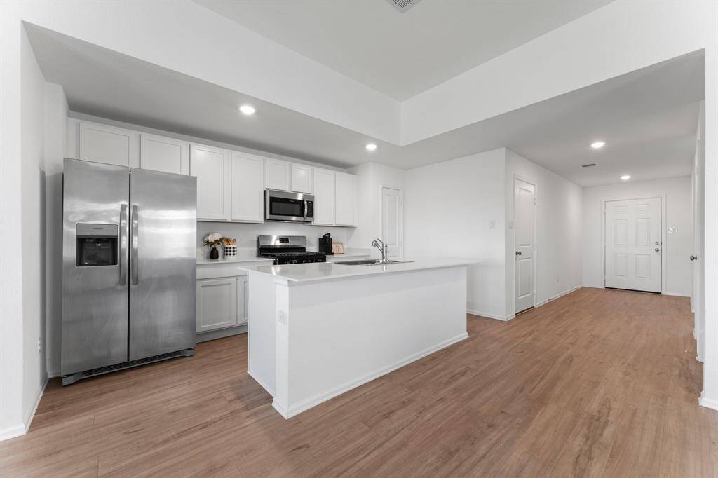 Another view of the kitchen which features amble cabinet and countertop space!