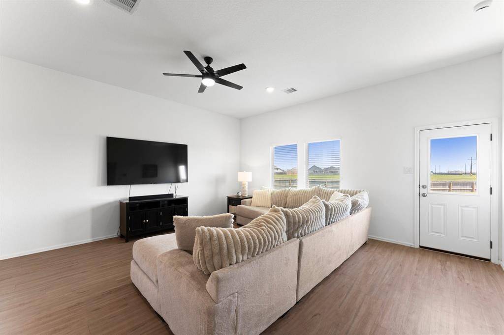 The spacious family room features two oversized windows, perfect for family gatherings!