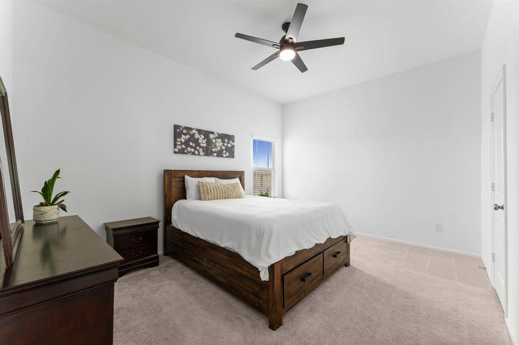 The primary suite is located on the bottom level and features a sleek modern ceiling fan!