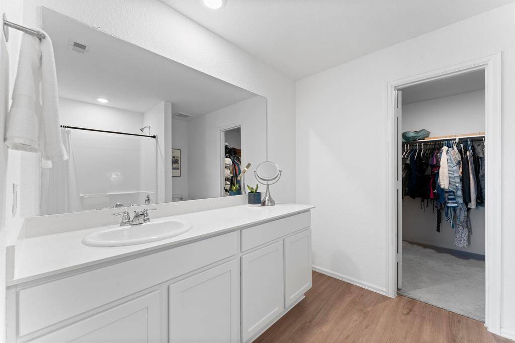 The primary bathroom features a beautiful white on white color combination!