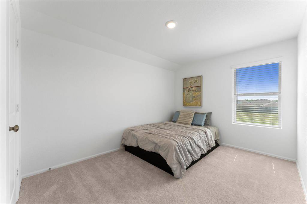 This spacious secondary bedroom features plush carpet and a nice sized window that lets in plenty of natural light!
