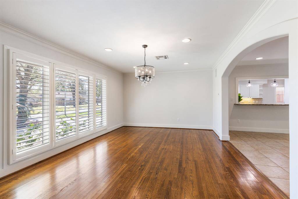 Enjoy an elegant dining experience with wood floors and floor-to-ceiling windows. Control your level of privacy with the added convenience of plantation shutters.