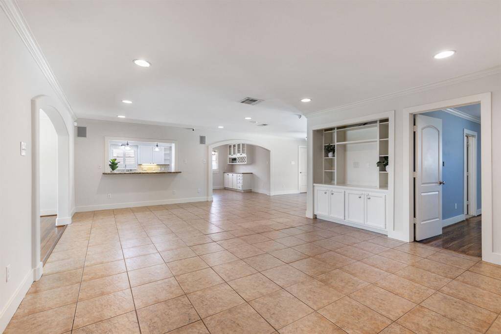 Located between the primary bedroom and kitchen, this spacious living room features plenty of room to relax, along with additional built-ins for added appeal.