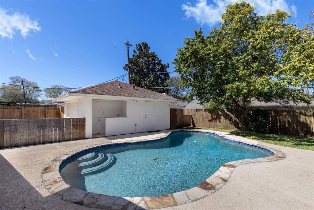 The pool is surrounded by expansive decking, ideal for lounging and soaking up the sun. For added convenience, the pool bath is the third bath and includes a full bathroom with a shower and a poolside bar with a sink. Entry to bathroom is on right side of garage.