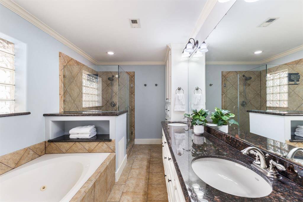 The primary bathroom boasts many updates, while still retaining some of the home's classic original features and charm.
