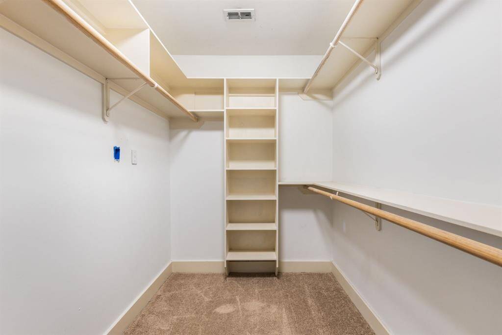 An oversized walk in closet with smart use of space that's perfect for all your storage and organizational needs.