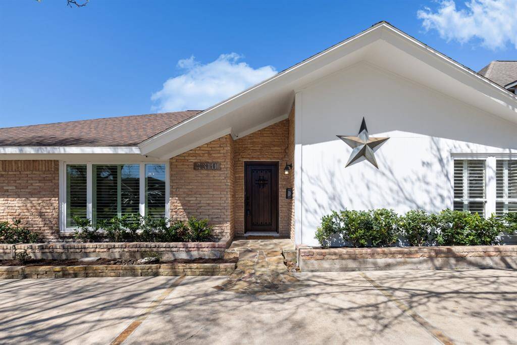 Follow the cobblestone path that leads you to the front of the house, offering a welcoming touch.