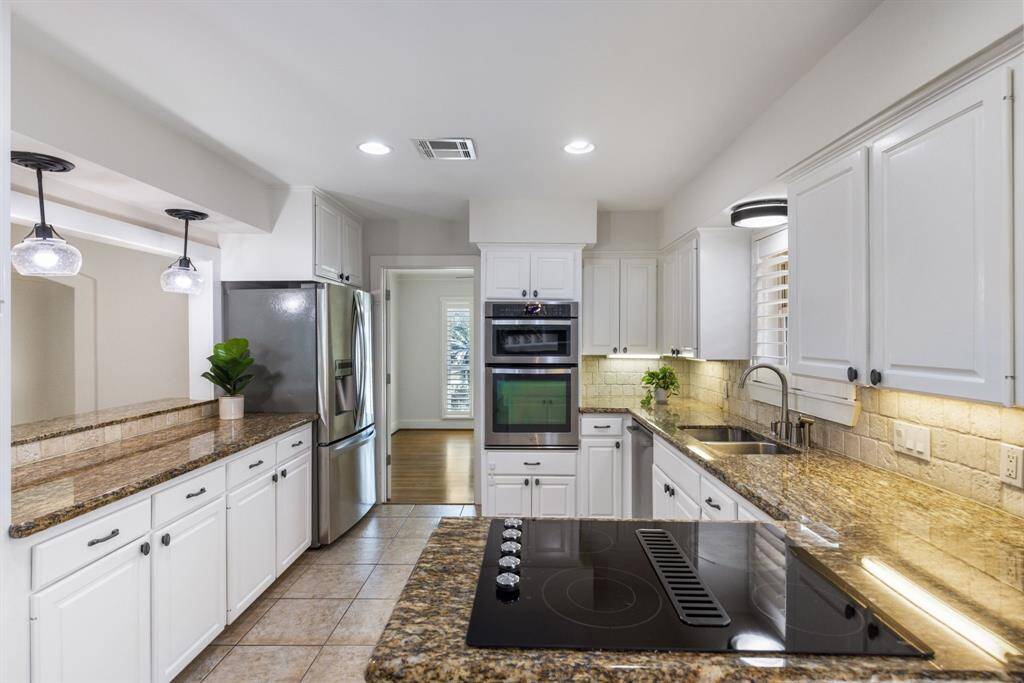 The kitchen features elegant granite countertops paired with high-end stainless steel appliances, all of which are included!
