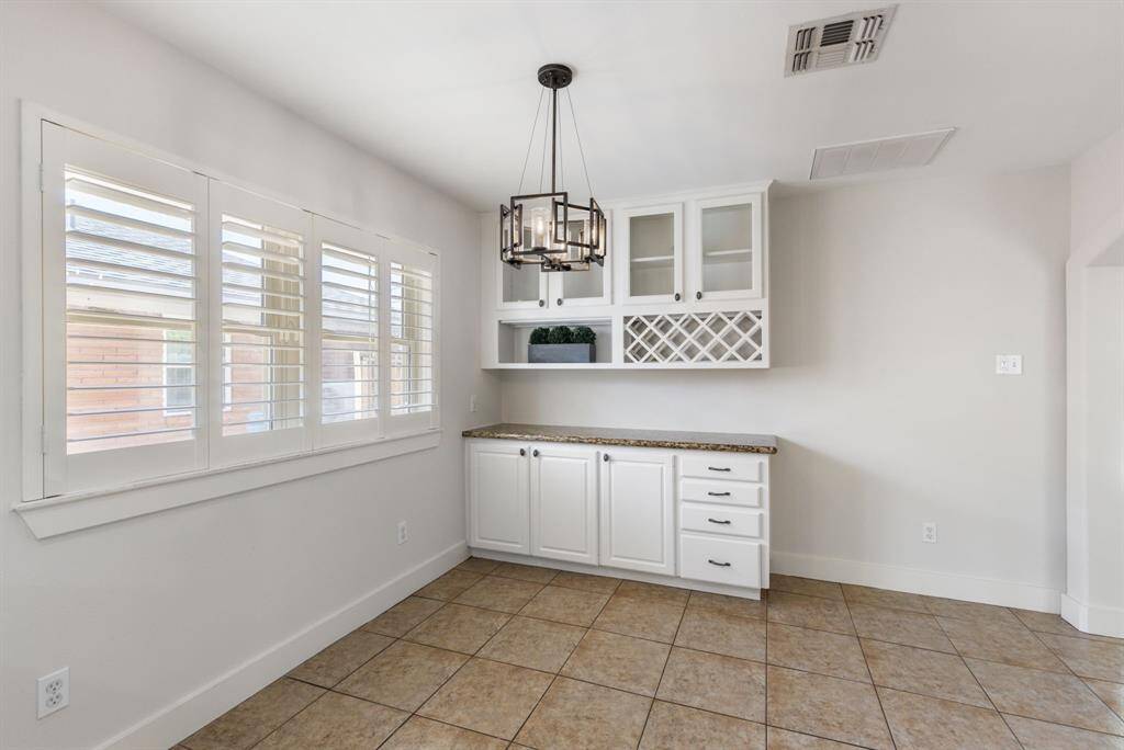 This space makes great use of natural light, thanks to the windows lining the wall. They are even complete with plantation shutters.