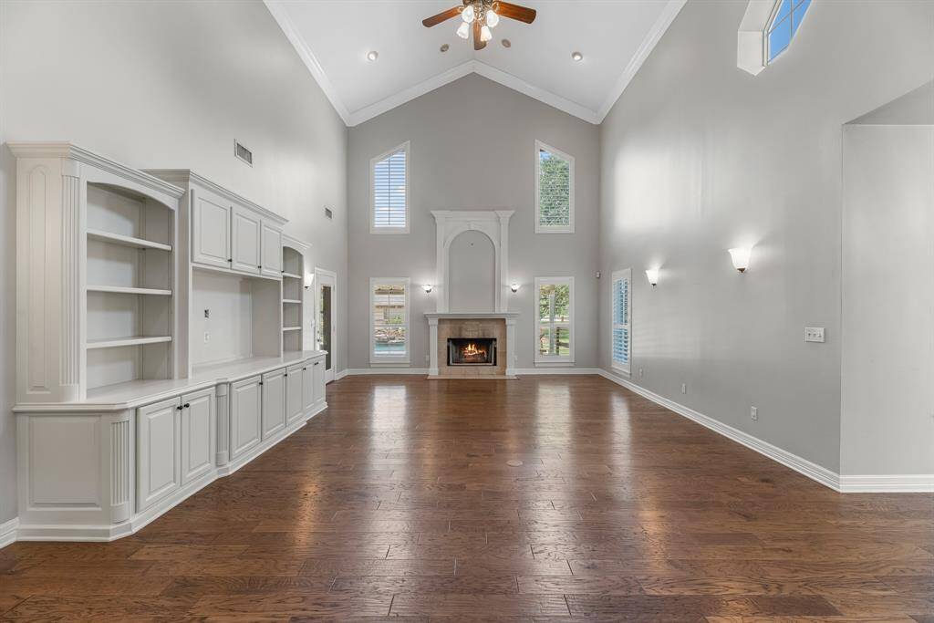 A wall of expansive windows frames the wood-burning fireplace and draws your eye to the serene backyard views, creating a seamless connection between the indoors and the natural beauty outside.