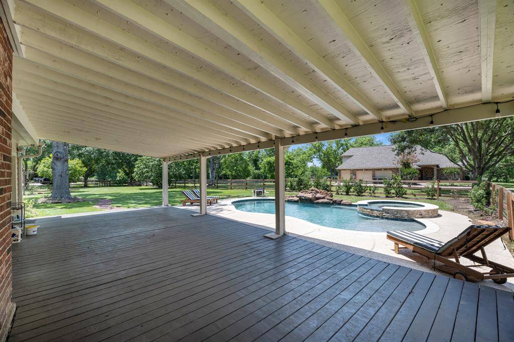 Step outside to a spacious covered patio with decking—an inviting retreat perfect for relaxing and entertaining, with plenty of room for all your outdoor furniture.