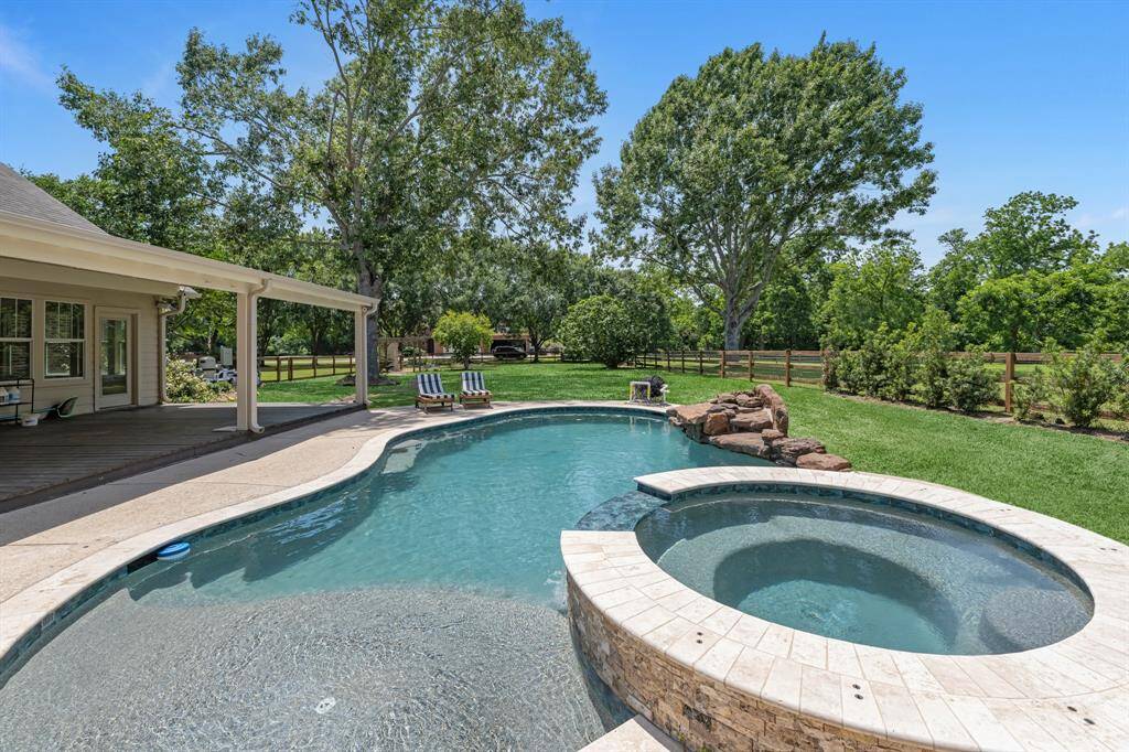 Relax in the spacious circular spa, perfect for seating several guests, while soaking in peaceful views of the towering trees that surround your property.