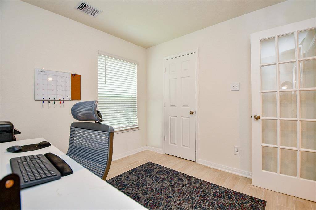 Tucked away from the main living space, the downstairs room is perfect as an office, guest bedroom, or flexible living area and includes a large walk-in closet for ample storage. A nearby half bath adds convenience and functionality to this versatile space.