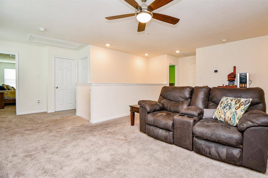 The generously sized game room serves as the heart of the upstairs, creating a central gathering space. It thoughtfully separates the primary bedroom suite from the other bedrooms, providing both privacy and a comfortable flow.