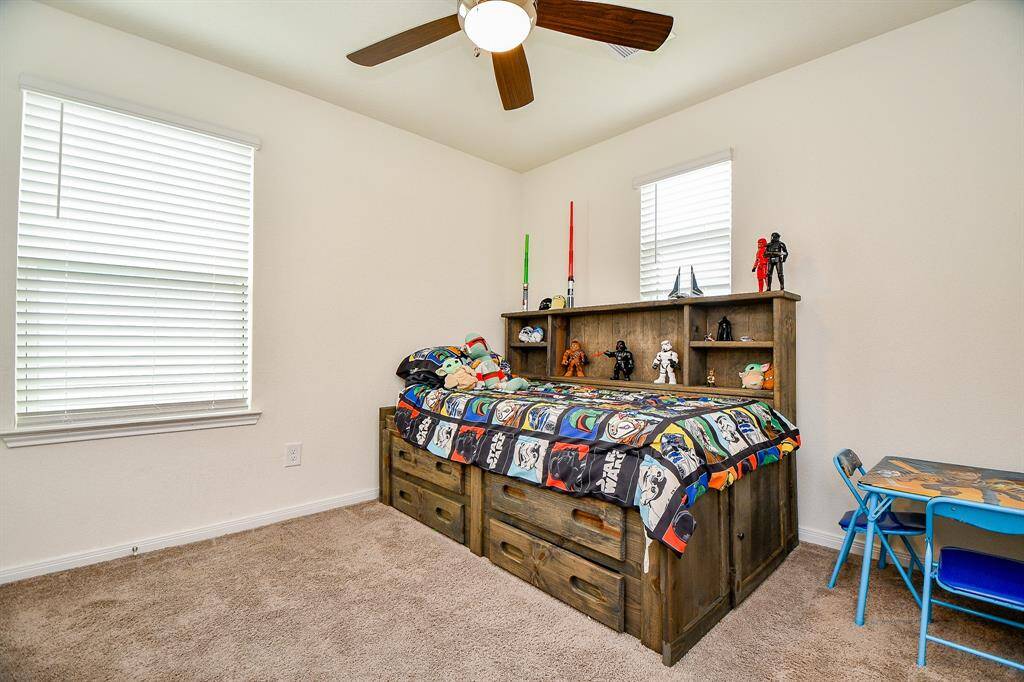 This bedroom features a comfortable layout, nice windows that bring in natural light, and a generously sized closet—making it a flexible and inviting space.