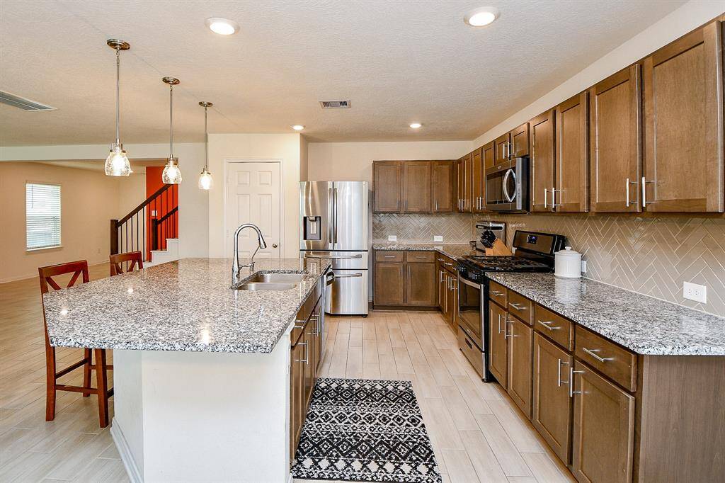 Enjoy generous counter space featuring elegant granite countertops, complemented by abundant cabinetry that offers ample storage.