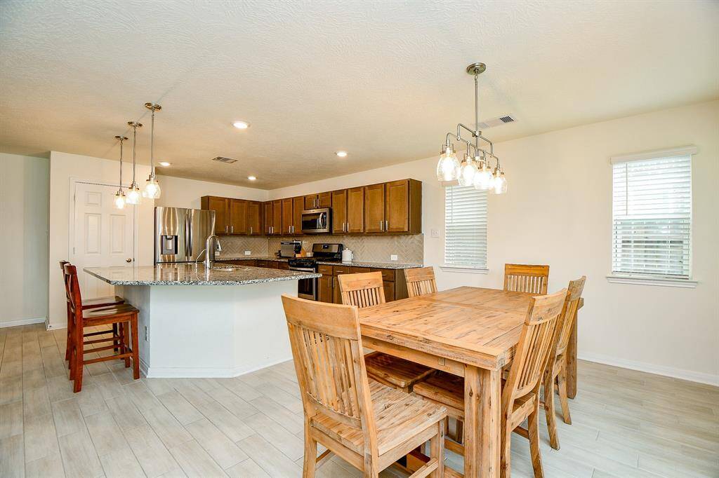 The breakfast area is spacious enough to accommodate a large dining table, making it ideal for casual meals or gatherings with family and friends. Its proximity to the kitchen and patio adds convenience and flow for everyday living.