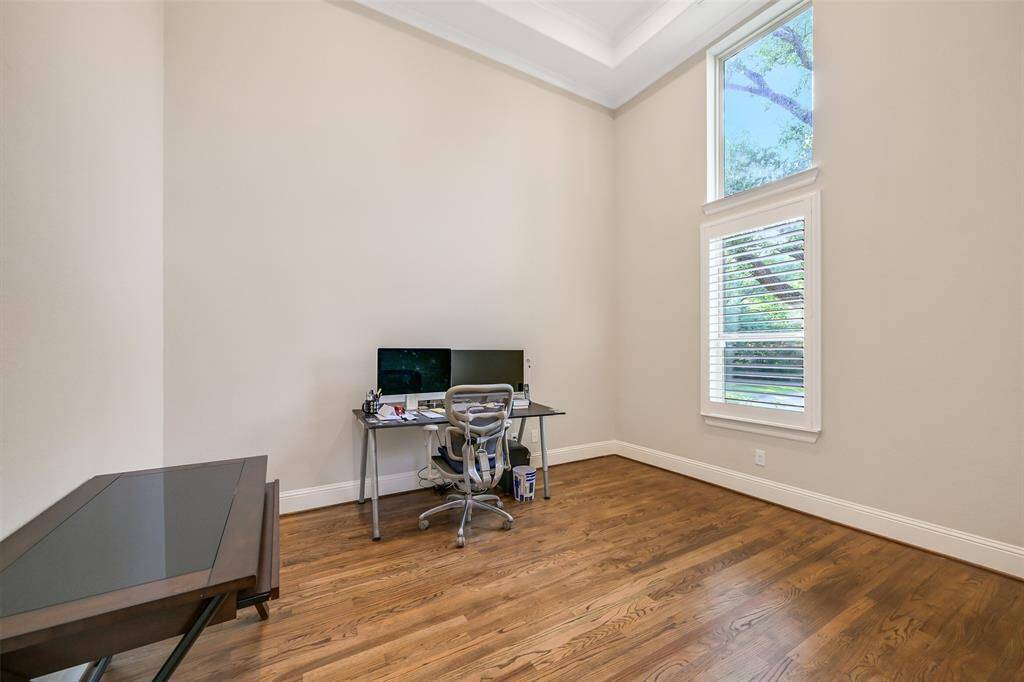 The formal study is off the netry and also features two story ceilings.