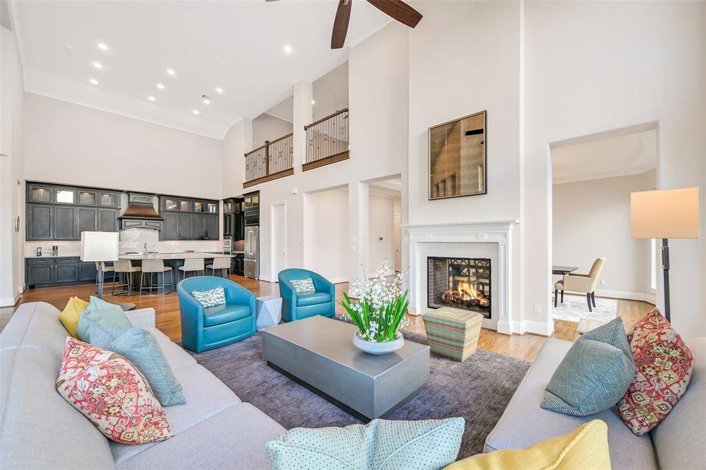 Another view of the family room with two story ceilings and open to the large island kitchen.