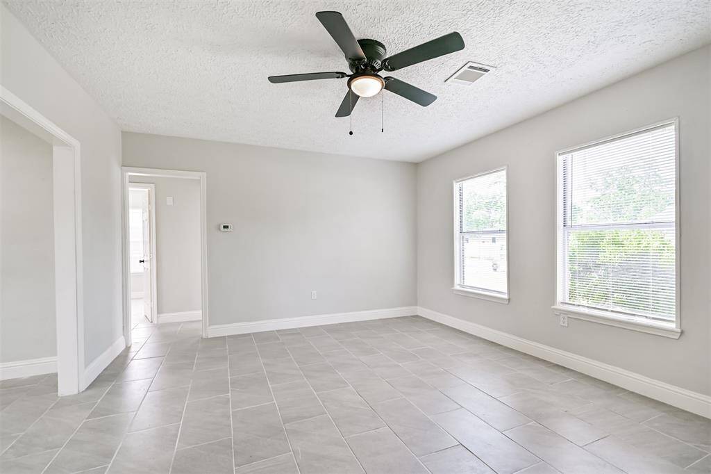 The living room offers dual front-facing windows allowing natural light to pour in, creating a bright and welcoming environment.